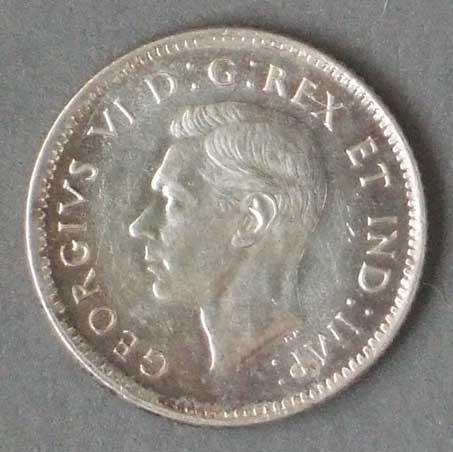Color photo: Obverse view of 10 cent coin - Canada 1945