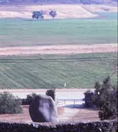 Color photo: View of valley and monument entrance from behind monument