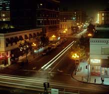 Color photo: Nighttime view, looking east, of E St. from Horton Plaza