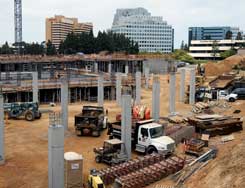 Color photo: Elevated view of UTC shopping center construction with neighboring high-rises in distance
