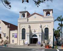 Color photo: View of Catholic Chruch from across State St.