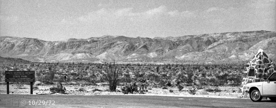 B/W photo: Sign and plaque marker on side of desert highway - Embedded text: 10/29/72