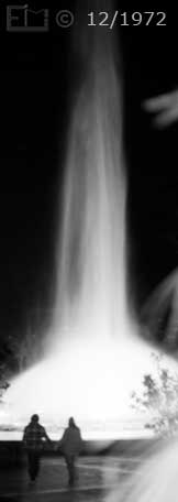 Night time photo of couple silhouetted by lighted fountain - Embedded text: 12/1972