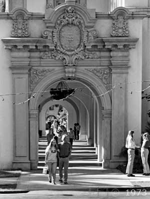 B/W photo: Pedestrians on arched sidewalk of El Prado - Embedded text: 1973