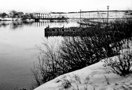 grayscale photograph: snowscape, bridge to Sydney