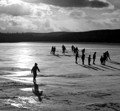 grayscale photograph: skaters on frozen lake