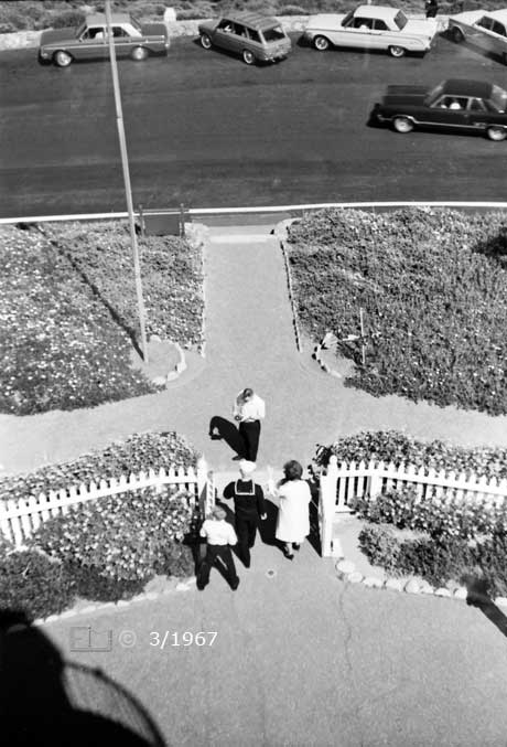 B/W photo: View of tourists taking photographs; taken from atop lighthouse - Embedded text: 3/1967