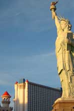 Color photo: Statue of Liberty and Excalibur Hotel/Casino at sunrise