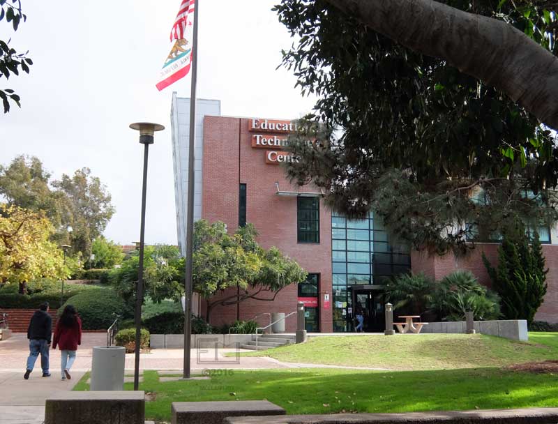Two pedestrians approaching Educational Technical Center (B) building