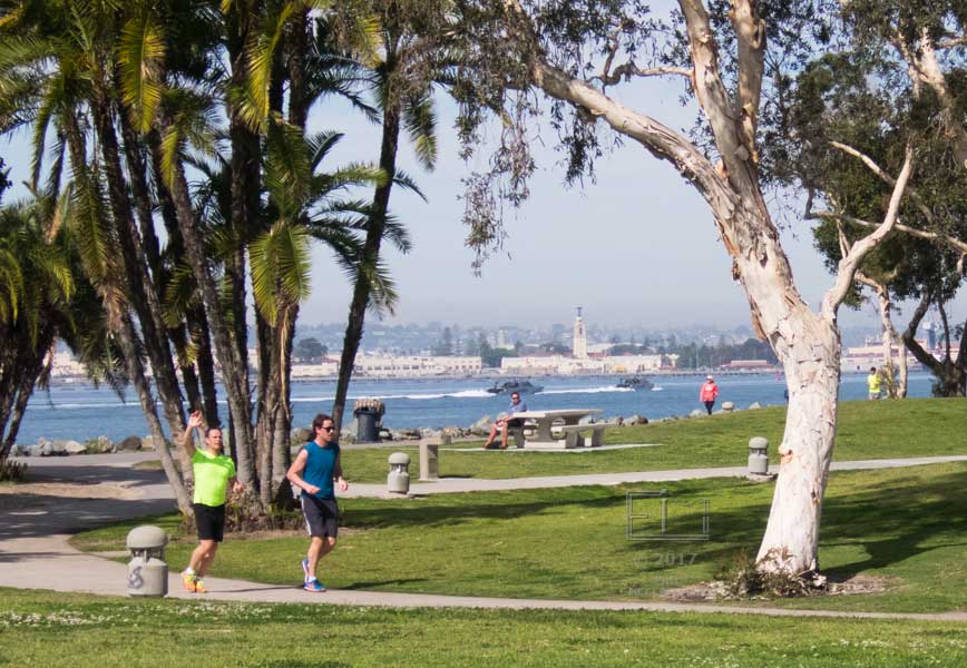One of two approaching runners waves as going by