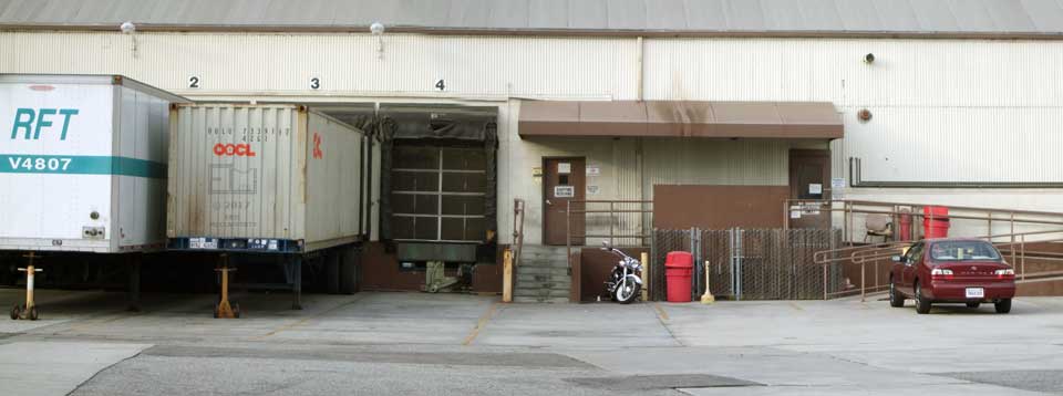Wide view of loading dock area - Two trailers at loading bays on left