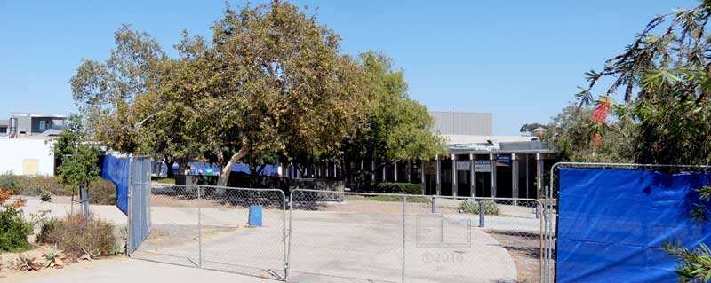 View of fence surrounding old bookstore/cafeteria buildings, from top of picnic table