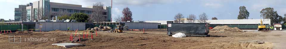 Wide view of large, cleared field in foreground, 1 and 4 story Mesa College buildings in background
