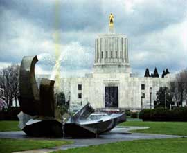Color photo: Full view of water fountain with Capital building as backdrop