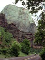 Color photo: Highway traffic dwarfed by monumental landscape