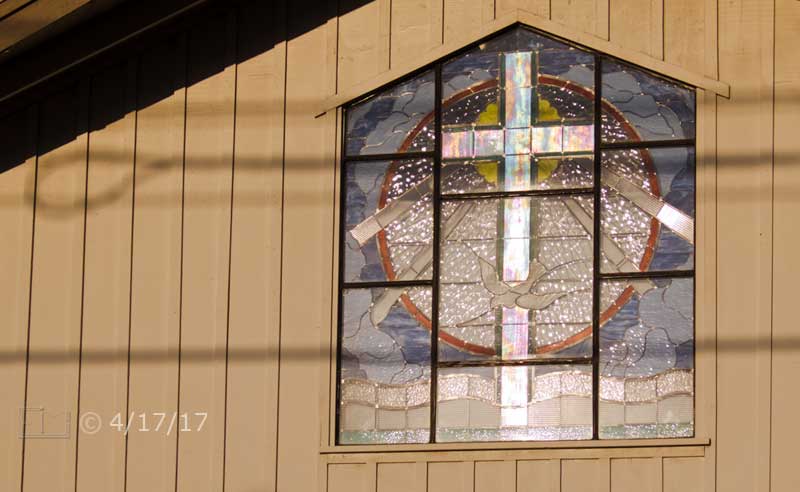 Color photo: Exterior view of a church's stained glass window - Embedded text: 4/17/17