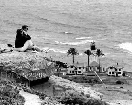 B/W photo: Couple viewing ocean with binoculars - Embedded text: 5/28/89