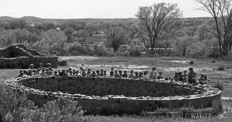 B/W photo: Class of schoolchildern view interior of uncovered kiva - Embedded text: 5/11/73