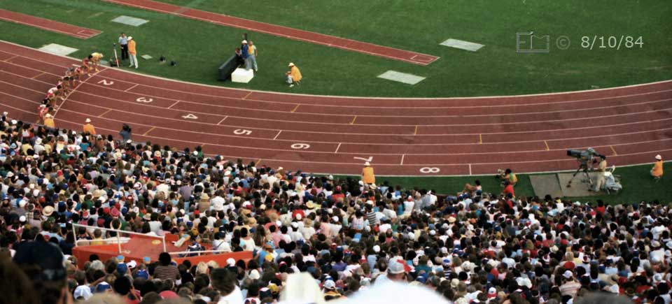 Color photo: Contestants crouched to start 3000 meter race - Embedded text: 8/10/84