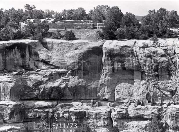 B/W photo: Closer view of Sun Temple ruins on plateau/mesa and ruins on side of cliff - Embedded text: 5/11/73
