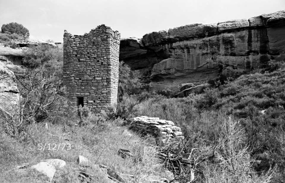 B/W photo: View of Square Tower ruin with canyon wall in background - Embedded text: 5/12/73