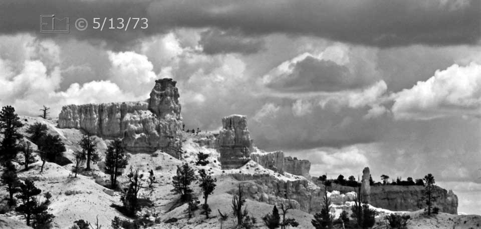 B/W photo: Dramatic sandstone formations and clouded sky - Embedded text: 5/13/73