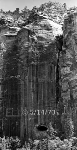 B/W photo: Large opening cut into vertical face of cliff - Embedded text: 5/14/73