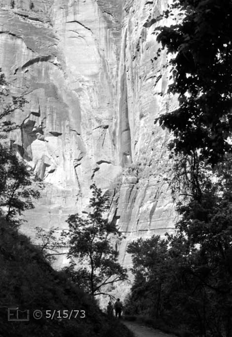 B/W photo: Stream waterfall from near top of high vertical cliff; framed by trees - Embedded text: 5/15/73