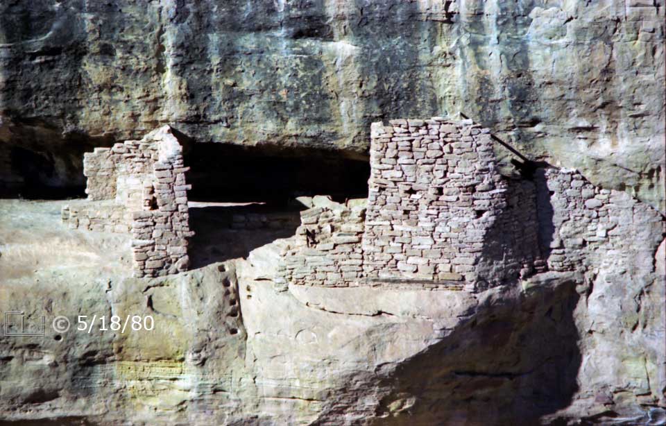 Color photo: Zoomed-in close front view of cliff dwelling ruins from across canyon - Embedded text: 5/18/80