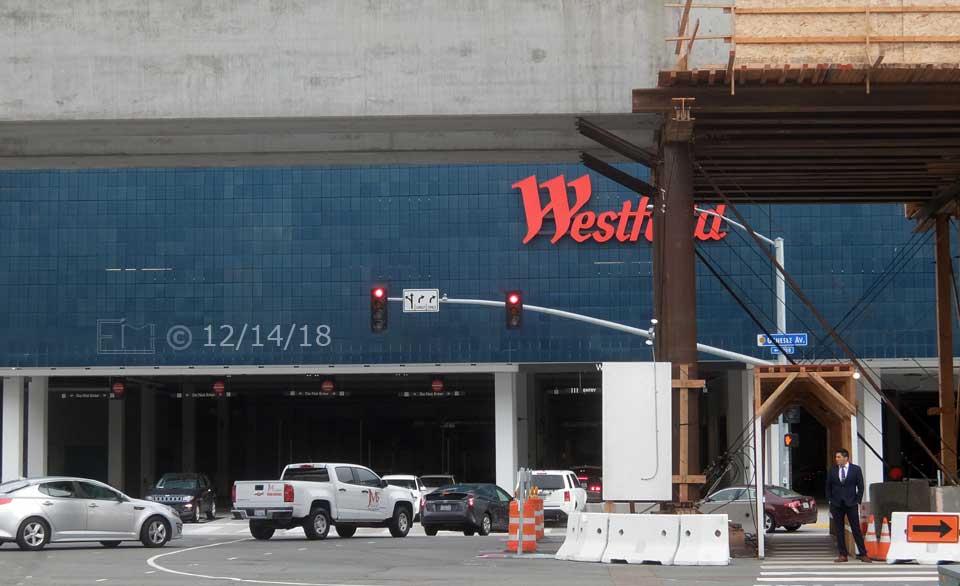 Color photo: Trolley line construction at Genesee Ave/Esplanade Ct entrance to UTC - Embedded text: 12/14/18