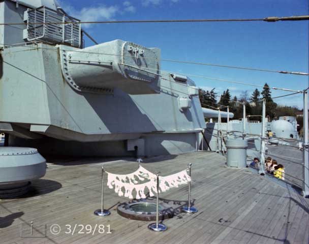 Color photo: Forward looking view of large gun turret and surrender plaque - Embedded text: 3/29/81