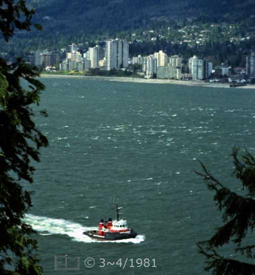Color photo: Elevated view of tugboat with North Vancouver on far shore - Embedded text: 3~4/1981