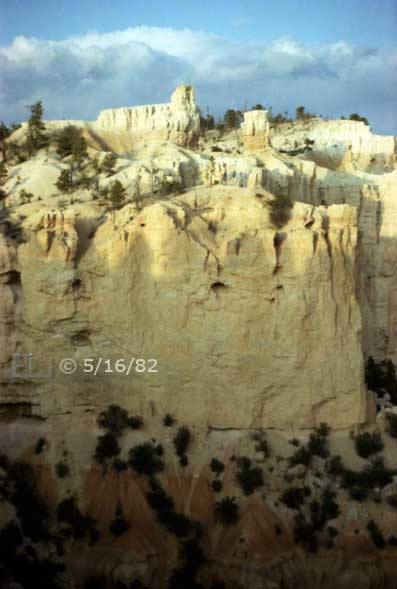 Color photo: Portrait view of rock formations atop enormous Cliffside - Embedded text: 5/16/82