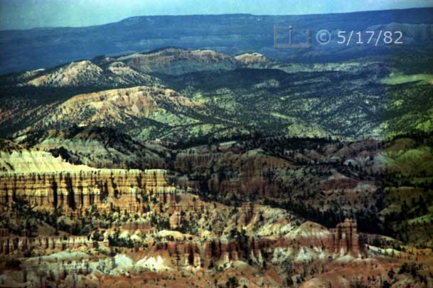 Color photo: Telefoto view of eroded rock landscape - Embedded text: 5/15/82