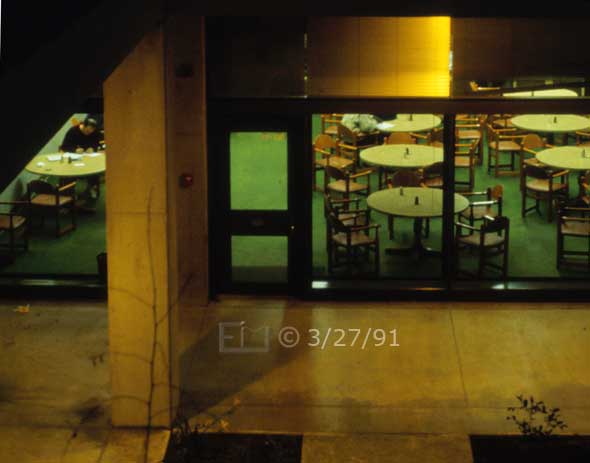 color photo: Elevated, night-time view of cafateria/study area? - Embedded text: 3/27/91