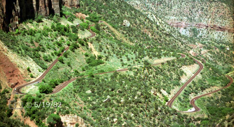 B/W photo: Telephoto view of highway switchbacks from tunnel to Zion Canyon - Embedded text: 5/1/82