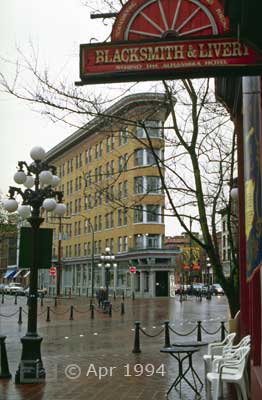 Color photo: Wide, across the street view of 'Flatiron' style building - Image taken: 4/7~12/1994