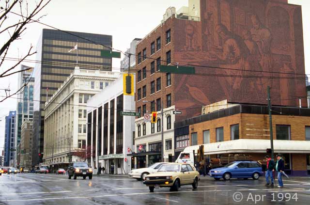 Color photo: Vancouver street scene with graphic on side of red brick building - Image taken: 4/7~12/1994
