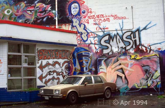 Color photo: Multiple wall art paintings in alleyway - Image taken: 4/7~12/1994