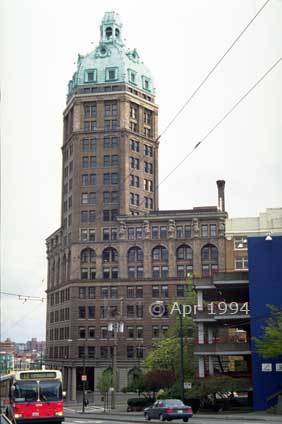 Color photo: Bus and traffic in foreground of 'Crow's Nest' building - Image taken: 4/7~12/1994