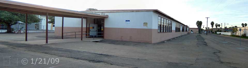Color photo: View of covered walkway leading to old West City Center building and alley on its east - Embedded text: 1/21/09