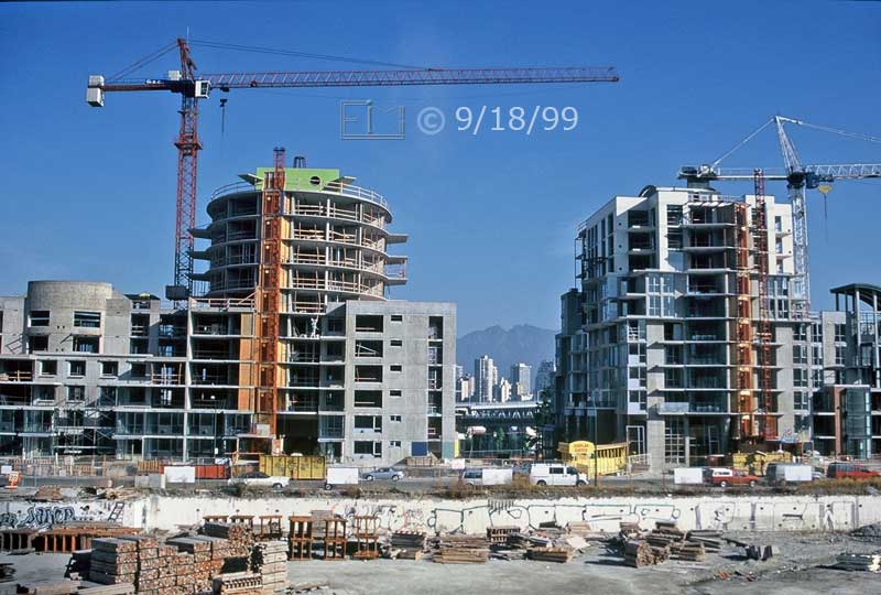 Color photo: Cranes and new apartment buildings under construction - Embedded text: 9/18/99