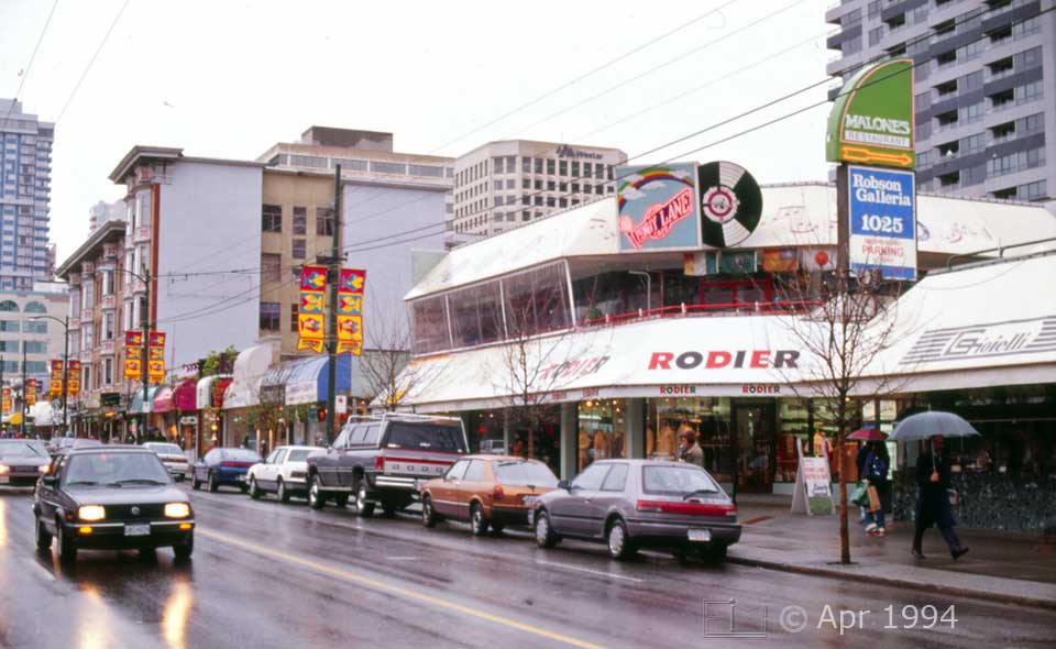 Color photo: Street traffic and buildings on Robson street - Image taken: 4/7~12/1994