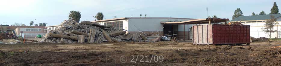 Color photo: Looking north at rubble pile and south end of old building - Embedded text: 2/21/09