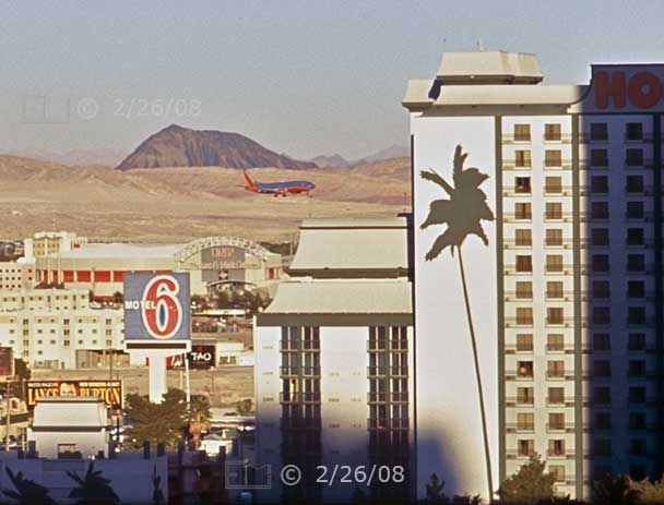 Film color photo: View from Excalibur room #712 of aircraft descending to land at Las Vegas airport - Embedded text: 2/26/08
