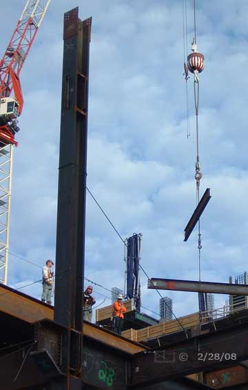 Dsc color photo: Crane moving iron girders on construction site  - Embedded text: 2/28/08
