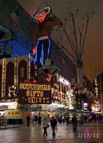 DSC color photo: View of neon cowboy on Fremont St - Embedded text: 2/17/11