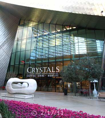 DSC color photo: Art sculpture in front of area businesses - Embedded text: 2/17/11