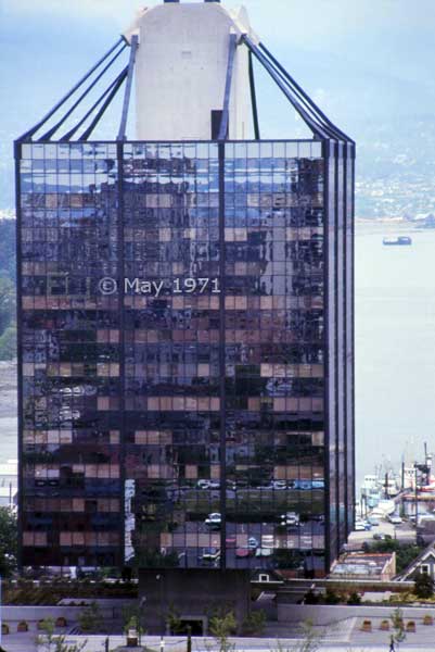 Color photo: High-rise building supported (suspended from) by its central column? - Embedded text: May 1971