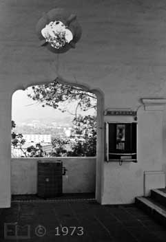 B/W photo: Passageway between arcade and buildings exterior walkway - Embedded text: 1/1973